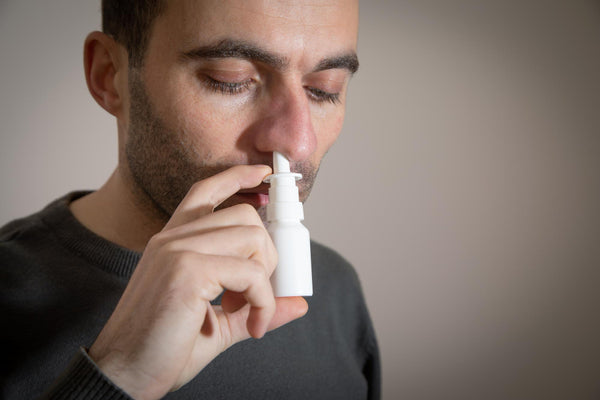 man with nasal drops