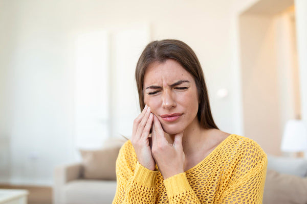 woman suffering from strong mouth pain